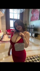 Youyoulama posing in red dress and a smal purse